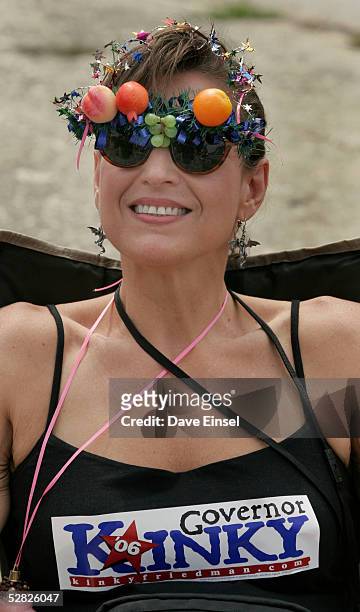 Gina Spada sits back and enjoys the festivities during the Everyone's Art Car Parade May 14, 2005 in Houston, Texas. Spada wears a bumper sticker in...
