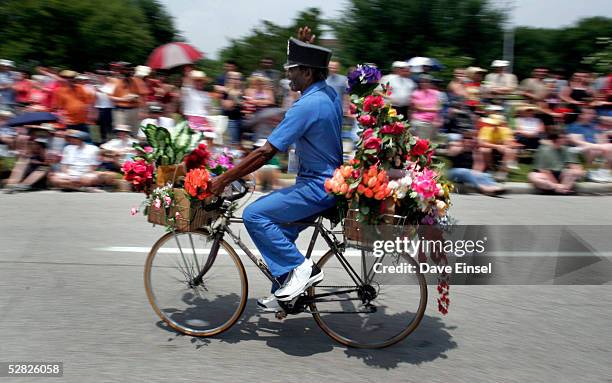 Houston artist Flower Man rides his bicycle during the Everyone's Art Car Parade May 14, 2005 in Houston, Texas. The parade includes around 280 cars...