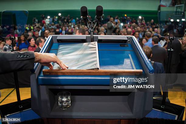 Glass of water rests under US President Barack Obama's podium at Flint Northwestern High School in Flint, Michigan, May 4 where he spoke after...