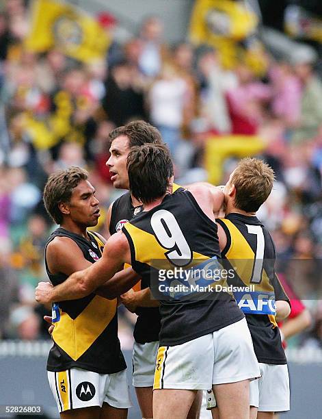 Richmond players congratulate Matthew Richardson for the Tigers during the AFL Round 8 match between the Collingwood Magpies and the Richmond Tigers...