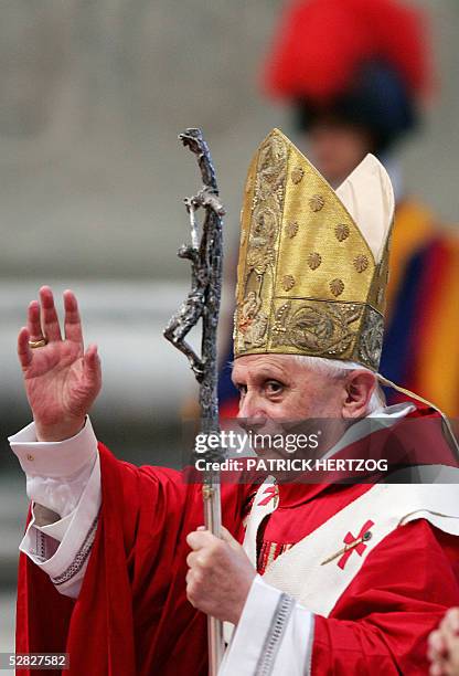 Pope Benedict XVI waves at pilgoms as he arrives for a mass of ordination of 21 new priests in St-Peter's basilica at the Vatican, 15 May 2005. The...