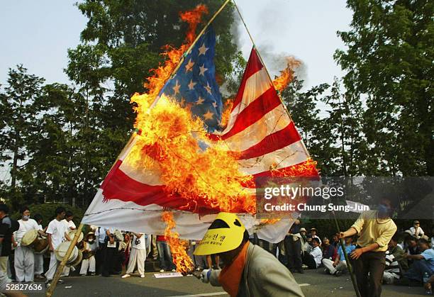 South Korean protesters burn a U.S. Flag during an anti-American demonstration near a South Korean Air Force base May 15, 2005 in Gwangju, South...