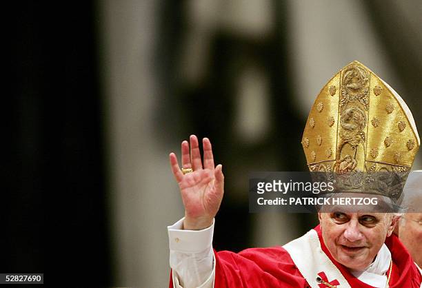Pope Benedict XVI waves to pilgrims during a mass for the ordination of 21 new priests in St Peter's basilica at the Vatican, 15 May 2005. The...
