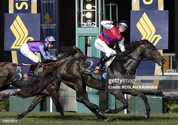 Mummify ridden by Danny Nikolic reaches the finishing line followed by Phoenix Reach ridden by Englishman Martin Dwyer in the 3 millions Singapore...