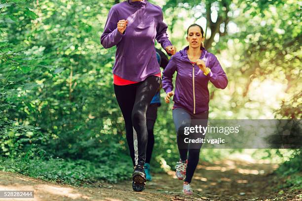 friends jogging in the nature - uphill stockfoto's en -beelden