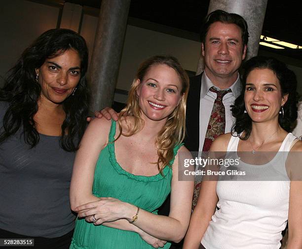 Actor John Travolta poses with Sarita Choudhury, Sarah Wynter and Laura Koffman when he visits The Rise of Dorothy Hale Off-Broadway at St. Lukes...