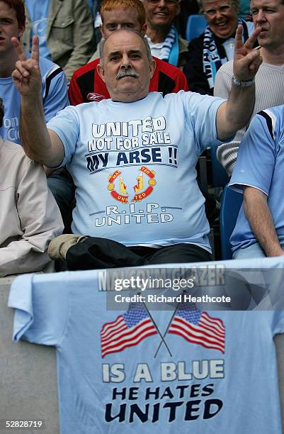 Manchester City fans display images about the Glazier takeover of rivals Manchester United during the FA Barclays Premiership match between...