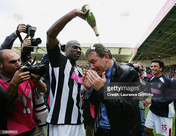 Kevin Campbell pours champagne over Bryan Robson of WBA after securing premiership status at the end of the Barclays Premiership match between West...