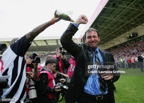 Kevin Campbell pours champagne over Bryan Robson of WBA after securing premiership status at the end of the Barclays Premiership match between West...