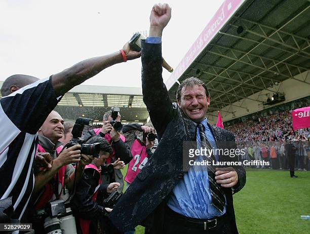 Kevin Campbell pours champagne over Bryan Robson of West Brom after securing premiership status at the end of the Barclays Premiership match between...