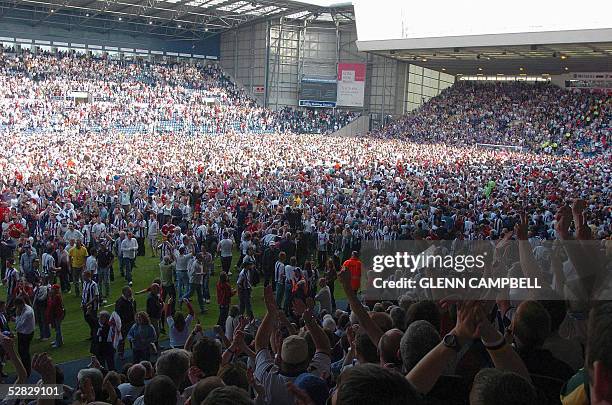 West Bromwich Albion fans celebrate on the pitch after beating Portsmouth 2-0 in their premiership match and escaping relegation in West Bromwich, 15...