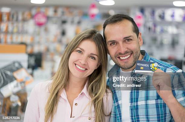 couple holding a loyalty card - loyalty stock pictures, royalty-free photos & images