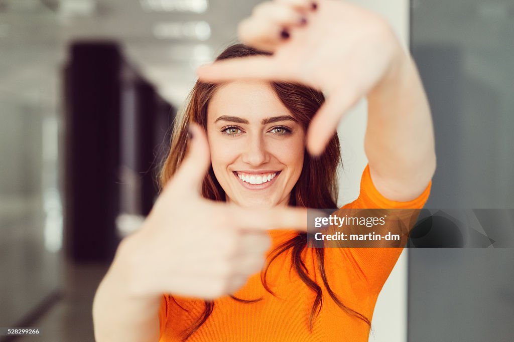 Young woman framing with hands