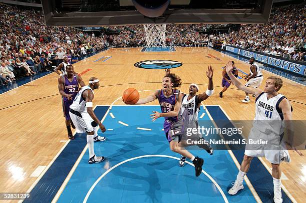 Steve Nash of the Phoenix Suns goes to the basket against Jason Terry and Dirk Nowitzki of the Dallas Mavericks in Game four of the Western...