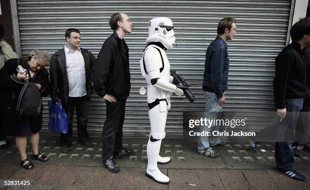 Man dressed as a Storm trooper queues to get in to the first ever screening of the entire six-film Star Wars saga, in Leicester Square on May 16,...