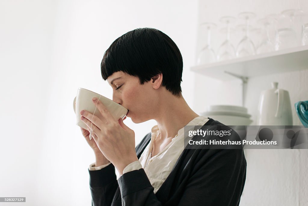 Young Woman Enjoying A Cup Of Tea