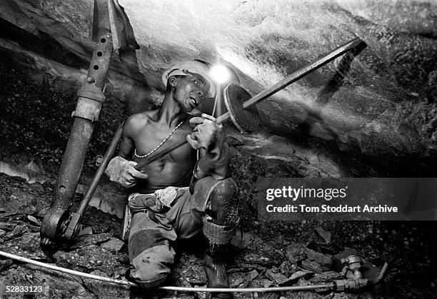 Miner excavating gold at the Kloof Gold Mine near Carltonville, South Africa. Miners work thousands of metres underground in extreme temperatures to...