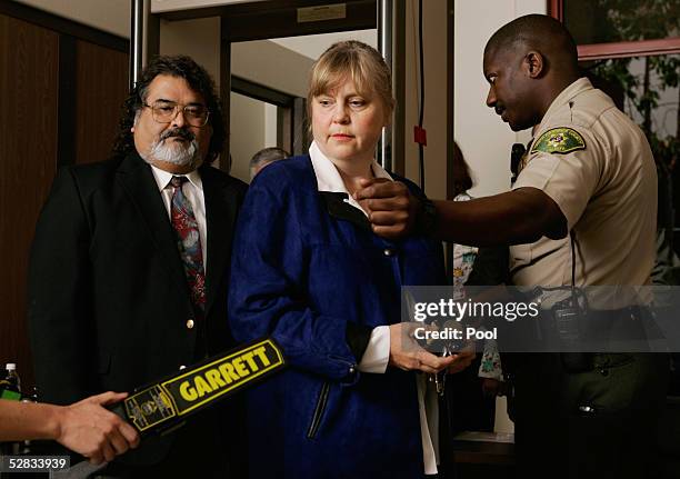 Defense witnesses Dr. Jean Seamount and Jesus Castillo pass through a security checkpoint at the Santa Barbara County Courthouse as they arrive for...