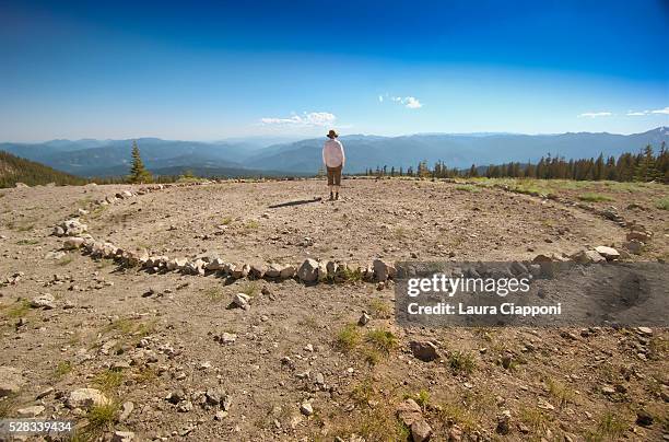 person standing in a circle of stones mount shasta; california united states of america - mount shasta bildbanksfoton och bilder