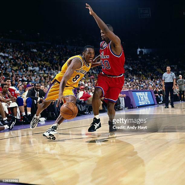 Kobe Bryant of the Los Angeles Lakers drives baseline against the Washington Bullets during the NBA game on February 2, 1997 in Los Angeles,...