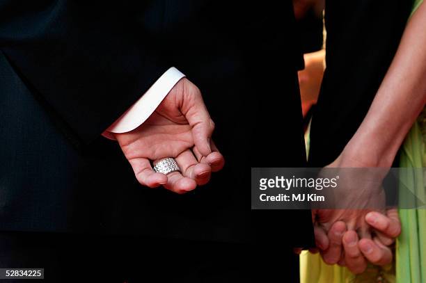 David and Victoria Beckham hold hands as they arrive at the Laureus World Sports Awards on May 16, 2005 at the Estoril Casino, Estoril, Portugal.