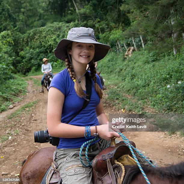 a girl riding a horse on a trail; finca el cisne, honduras - cisne stock pictures, royalty-free photos & images
