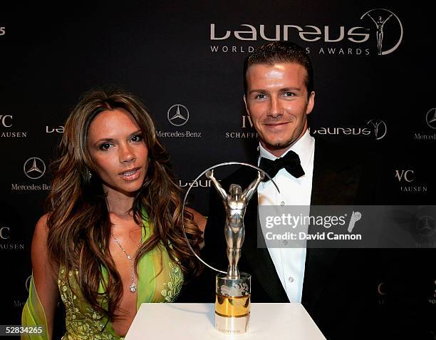 David and Victoria Beckham pose with the Laureus trophy during the Laureus World Sports Awards on May 16, 2005 at the Estoril Casino, Estoril,...