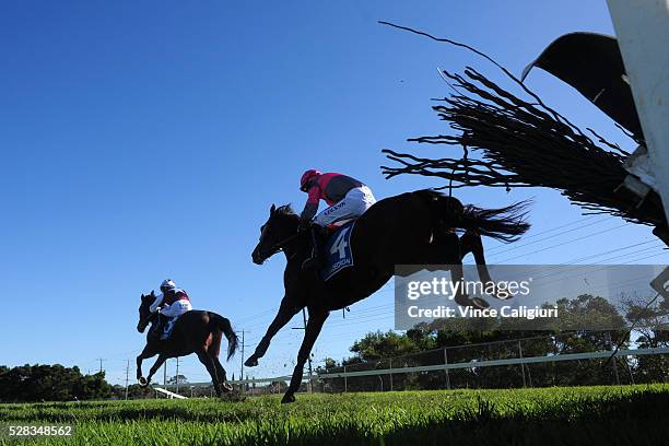 Shane Jackson riding Gold Medals gives chase to John Allen riding Twin Tea Bags before winning Race 1 during Grand Annual Day at Warrnambool Race...