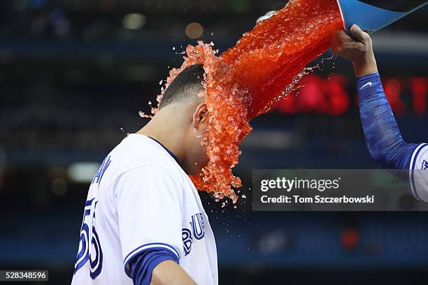 Russell Martin of the Toronto Blue Jays has Gatorade dumped on him by Darwin Barney after hitting a game-winning RBI single during MLB game action...