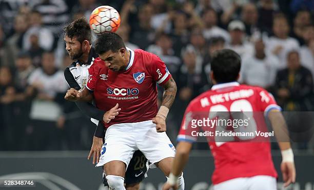 Felipe of Corinthians fights for the ball with Mauricio Victorino of Nacional during a match between Corinthians and Nacional URU as part of round of...