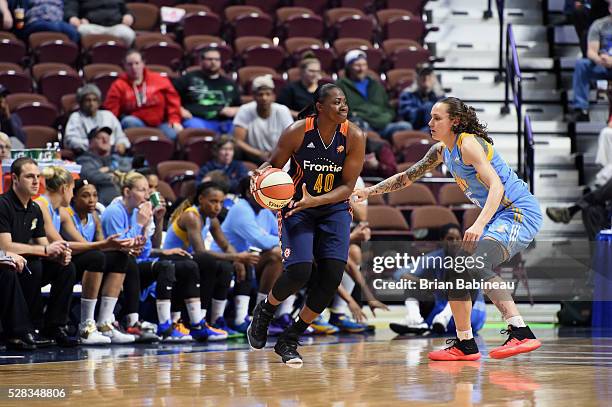 Shekinna Stricklen of the Connecticut Sun handles the ball against Jacki Gemelos of the Chicago Sky during a preseason game on May 4, 2016 at the...