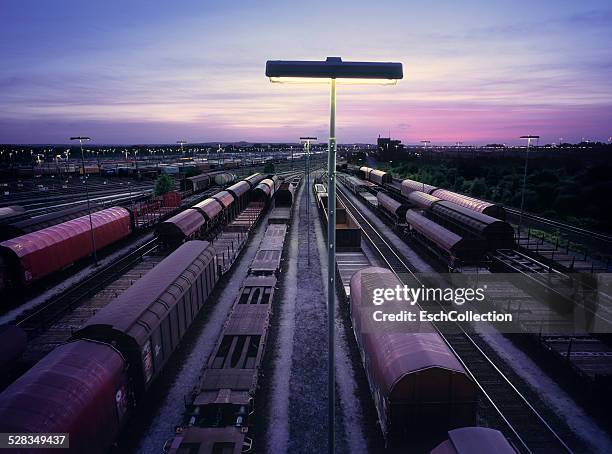 sunset at large shunting yard in hamburg, germany - boxcar stock-fotos und bilder