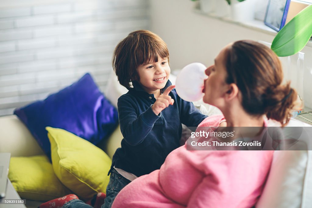 Small boy playing with his mother