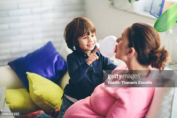 small boy playing with his mother - bubble gum stock pictures, royalty-free photos & images