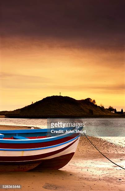 alnmouth, northumberland, england; boat on sunset beach - alnmouth beach ストックフォトと画像