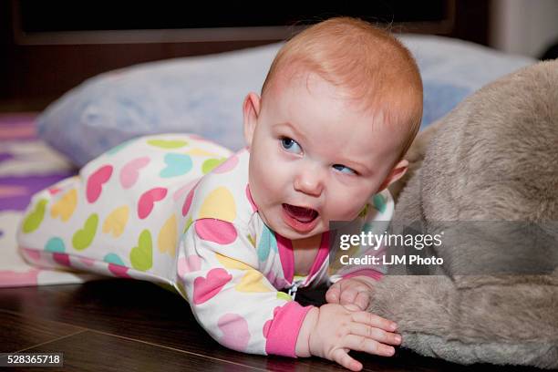 baby girl with a funny facial expression; spruce grove alberta canada - bébé grimace photos et images de collection