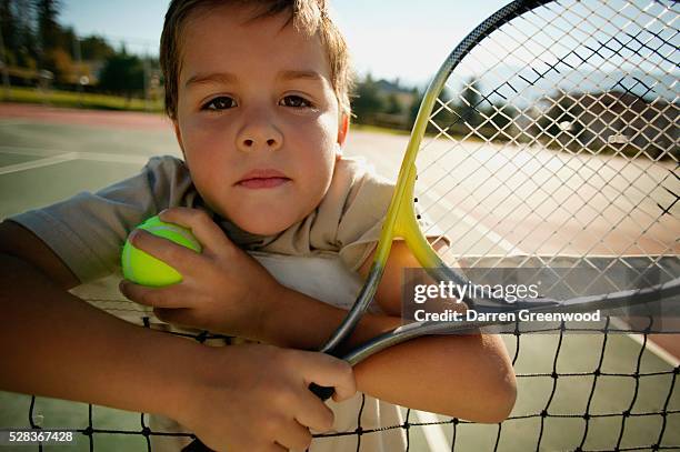 boy with tennis racket - tennis racquet stock pictures, royalty-free photos & images
