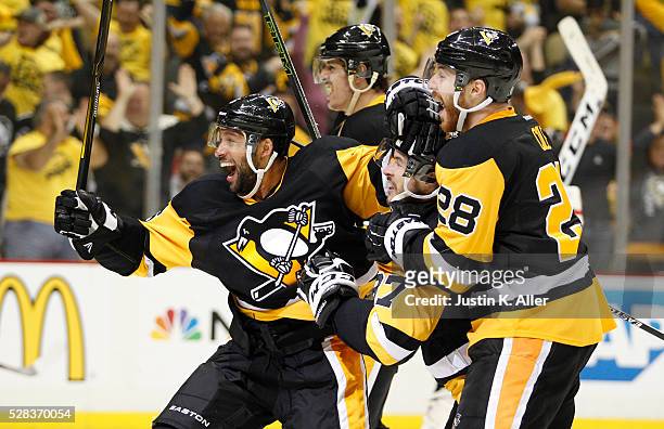 Trevor Daley, Sidney Crosby, Ian Cole and Evgeni Malkin of the Pittsburgh Penguins celebrate after Patric Hornqvist scored the game-winning overtime...