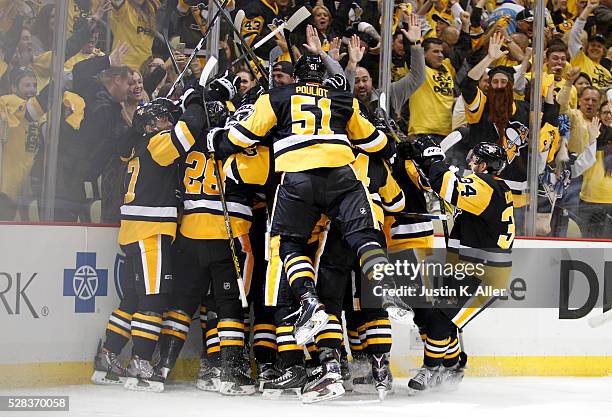 The Pittsburgh Penguins celebrate with Patric Hornqvist of the Pittsburgh Penguins after scoring the game-winning goal in overtime against the...