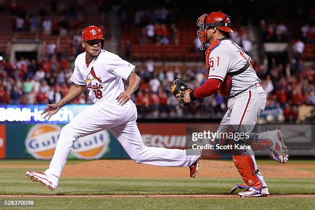 Carlos Martinez of the St. Louis Cardinals gets caught in a rundown by Carlos Ruiz of the Philadelphia Phillies during the ninth inning at Busch...