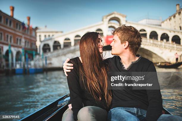 romantic couple togetherness on the gondola in venice - venedig gondel stock-fotos und bilder