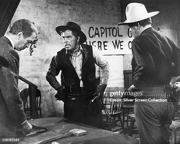 American actors James Stewart , Lee Marvin and John Wayne in 'The Man Who Shot Liberty Valance', directed by John Ford 1962. They play the roles of...