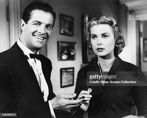 American actors Robert Cummings as Mark Halliday and Grace Kelly as Margot Mary Wendice, in a scene from 'Dial 'M' for Murder', directed by Alfred...