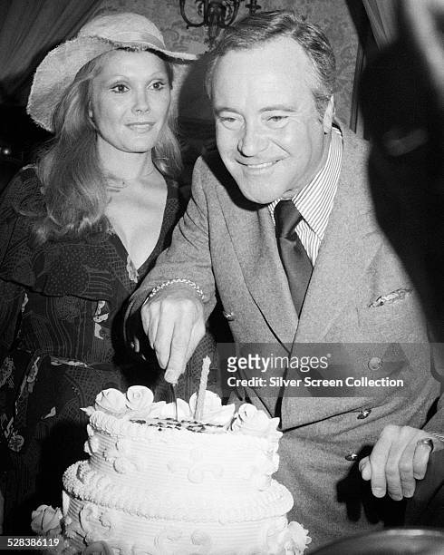 American actor Jack Lemmon cuts the cake at his 50th birthday party, at the Plaza Hotel, New York City, 20th February 1975. On the left is Lemmon's...