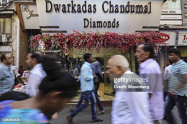 Pedestrians walk past the Dwarkadas Chandumal Jewellers store in the Zaveri Bazaar in Mumbai, India, on Monday, May 2, 2016. Prime Minister Narendra...