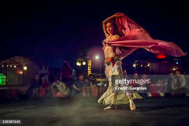 belly dancer in action with multicolored costume - buikdanseres stockfoto's en -beelden