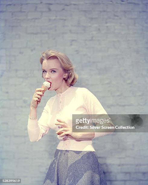 American actress Anne Francis eating an ice cream, circa 1955.