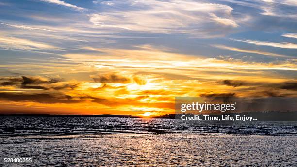 sunset over the sea - öresundsregionen stock-fotos und bilder