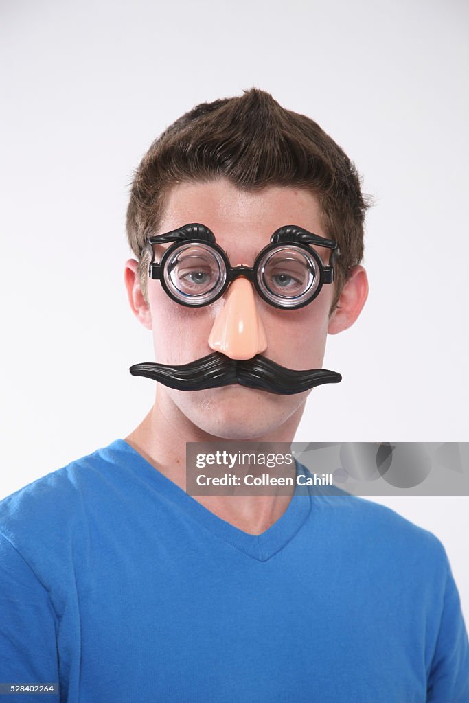 A Teenage Boy Wearing A Groucho Marx Mask; Troutdale Oregon United States Of America