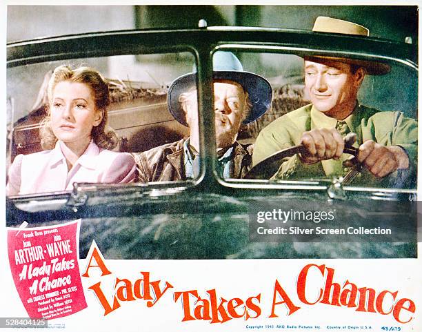 Lobby card for William A. Seiter's 1943 romantic comedy 'A Lady Takes A Chance', starring Jean Arthur and John Wayne.